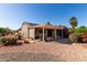 A backyard featuring desert landscaping, a covered patio and desert bushes at 20223 N Sundance Way, Surprise, AZ 85374