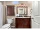 Bathroom boasts wood cabinets, granite countertops, a mirror and neutral paint at 20223 N Sundance Way, Surprise, AZ 85374