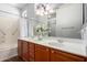 Bathroom features a double vanity, large mirror, and shower-tub combo at 20223 N Sundance Way, Surprise, AZ 85374