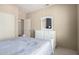 This bedroom includes a dresser, a closet, neutral paint and carpeted floors at 20223 N Sundance Way, Surprise, AZ 85374