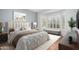 Sunlit bedroom features a cozy bench beneath shuttered windows, complemented by tasteful decor and plush furnishings at 20223 N Sundance Way, Surprise, AZ 85374