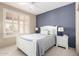 Bright bedroom features a ceiling fan, plantation shutters and a neutral color scheme at 20223 N Sundance Way, Surprise, AZ 85374