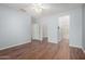 Empty bedroom featuring wood floors with views into en suite bath and walk in closet at 20223 N Sundance Way, Surprise, AZ 85374