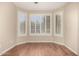 Bright, airy room featuring plantation shutters, hardwood floors, and neutral paint at 20223 N Sundance Way, Surprise, AZ 85374