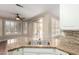 Granite counters and stainless sink in kitchen with views of breakfast nook and sliding doors to the patio at 20223 N Sundance Way, Surprise, AZ 85374