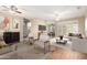 Bright living room featuring hardwood floors, ceiling fans, and open floor plan at 20223 N Sundance Way, Surprise, AZ 85374