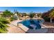Resort-style pool with swim-up table, surrounded by desert landscaping and privacy fence at 20223 N Sundance Way, Surprise, AZ 85374