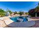 Backyard oasis featuring a stunning pool with a mosaic table and lush desert landscaping at 20223 N Sundance Way, Surprise, AZ 85374