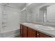 Bathroom featuring double sink vanity and a tub with shower at 2028 N 77Th Ln, Phoenix, AZ 85035