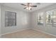 Spacious bedroom featuring tile flooring and two windows, offering ample natural light at 2028 N 77Th Ln, Phoenix, AZ 85035