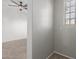 Corner of carpeted room with window and doorway into adjacent area at 2028 N 77Th Ln, Phoenix, AZ 85035