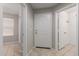 Welcoming entryway features neutral tones, tile flooring, and ample natural light at 2028 N 77Th Ln, Phoenix, AZ 85035