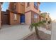 Attractive home exterior featuring desert landscaping, a blue door and stone accents at 2028 N 77Th Ln, Phoenix, AZ 85035