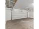 Spacious garage featuring a large door and concrete flooring at 2028 N 77Th Ln, Phoenix, AZ 85035