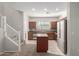 The kitchen features stainless steel appliances, tile flooring, and wood cabinets at 2028 N 77Th Ln, Phoenix, AZ 85035