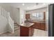 The kitchen includes stainless steel appliances, island seating, and tile flooring at 2028 N 77Th Ln, Phoenix, AZ 85035