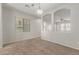 Spacious living room features plush carpeting, natural light, and an open floor plan at 2028 N 77Th Ln, Phoenix, AZ 85035