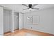 A well-lit bedroom features wood-look flooring, a ceiling fan, closet, and a window at 2121 N Center St # 198, Mesa, AZ 85201