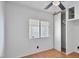 A well-lit bedroom features wood-look flooring, a ceiling fan, closet, and a window at 2121 N Center St # 198, Mesa, AZ 85201
