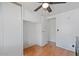 Clean and organized bedroom with a ceiling fan, closet and wood flooring at 2121 N Center St # 198, Mesa, AZ 85201