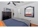 Cozy bedroom features neutral walls, ceiling fan, dresser and bright mirror at 2121 N Center St # 198, Mesa, AZ 85201