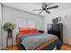 Warm and inviting bedroom with wood flooring, ceiling fan, and ample natural light at 2121 N Center St # 198, Mesa, AZ 85201
