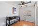 Cozy bedroom featuring wood floors, a ceiling fan, and a window for natural light at 2121 N Center St # 198, Mesa, AZ 85201