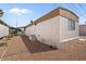 View of home's exterior featuring a white and beige exterior with a rock yard at 2121 N Center St # 198, Mesa, AZ 85201