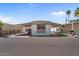 A mobile home with a covered porch, rock landscaping, and a carport at 2121 N Center St # 198, Mesa, AZ 85201