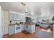 Efficient kitchen seamlessly connecting to the living room with bright cabinetry and wood countertops at 2121 N Center St # 198, Mesa, AZ 85201