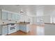Bright kitchen with wood floors, light blue cabinets, and an open floor plan at 2121 N Center St # 198, Mesa, AZ 85201