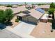 Aerial view of a well-maintained house featuring a three-car garage and desert landscaping at 22121 N Greenland Park Dr, Maricopa, AZ 85139