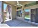 Covered back patio with outdoor ceiling fan, new sliding glass doors, and landscaped backyard at 22121 N Greenland Park Dr, Maricopa, AZ 85139