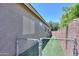 Side yard with a secure gate leading to a dedicated dog run at 22121 N Greenland Park Dr, Maricopa, AZ 85139