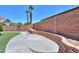 Backyard features manicured lawn and concrete retaining wall at 22121 N Greenland Park Dr, Maricopa, AZ 85139