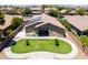 Aerial view of backyard featuring a grass lawn, patio and solar panels at 22121 N Greenland Park Dr, Maricopa, AZ 85139