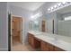 Double sink bathroom with vanity lighting, walk in closet, and glass shower stall at 22121 N Greenland Park Dr, Maricopa, AZ 85139