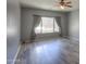 Bedroom with laminate wood flooring, neutral paint, and large windows with natural light at 22121 N Greenland Park Dr, Maricopa, AZ 85139