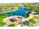 Aerial view of community park featuring a lake, playground, and walking paths at 22121 N Greenland Park Dr, Maricopa, AZ 85139