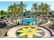 Aerial view of community pool with palm trees, seating and playground at 22121 N Greenland Park Dr, Maricopa, AZ 85139