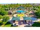 Aerial view of community pool, playground, and picnic shelters at 22121 N Greenland Park Dr, Maricopa, AZ 85139