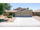 Charming home featuring a three-car garage, neutral color palette, and well-manicured landscaping at 22121 N Greenland Park Dr, Maricopa, AZ 85139