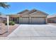 Charming single-story home with a well-manicured lawn and a three-car garage at 22121 N Greenland Park Dr, Maricopa, AZ 85139