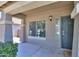 Inviting front porch with stylish lighting fixture and welcoming front door at 22121 N Greenland Park Dr, Maricopa, AZ 85139