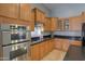 Gourmet kitchen showcasing granite countertops, wood cabinetry, and stainless steel appliances at 22121 N Greenland Park Dr, Maricopa, AZ 85139