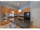Spacious kitchen featuring a large center island, granite countertops, and wood cabinetry at 22121 N Greenland Park Dr, Maricopa, AZ 85139
