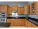 Bright kitchen with stainless steel appliances, granite countertops and wood cabinets at 22121 N Greenland Park Dr, Maricopa, AZ 85139