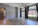 Spacious living room featuring hardwood flooring, ceiling fan, and sliding door access to patio at 22121 N Greenland Park Dr, Maricopa, AZ 85139