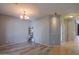 Bright and airy living room with wood-look flooring and modern chandelier at 22121 N Greenland Park Dr, Maricopa, AZ 85139