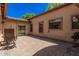 Tranquil outdoor patio featuring stone pavers with lush green landscaping and outdoor access gate at 24348 S 201St Ct, Queen Creek, AZ 85142